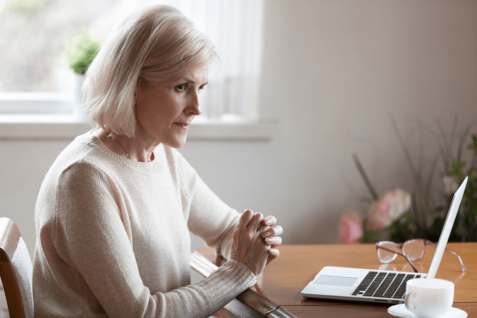 A senior woman researches how to prevent dementia wandering.