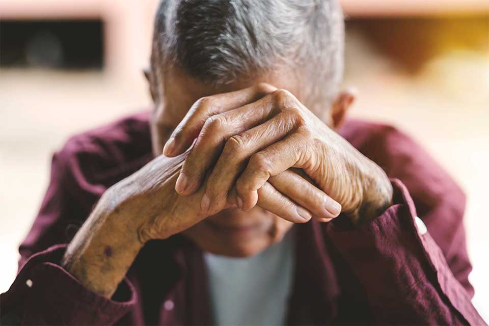 Elderly man in anguish as a result of elder abuse
