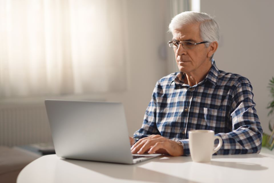 Elderly man filing taxes