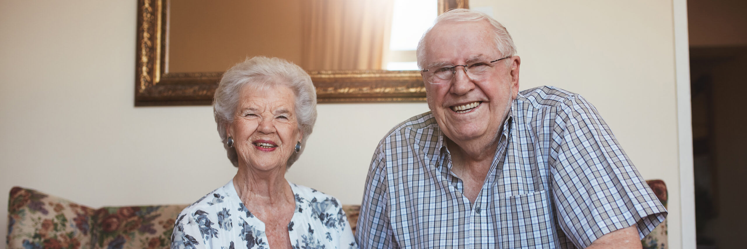 Seniors smiling on couch